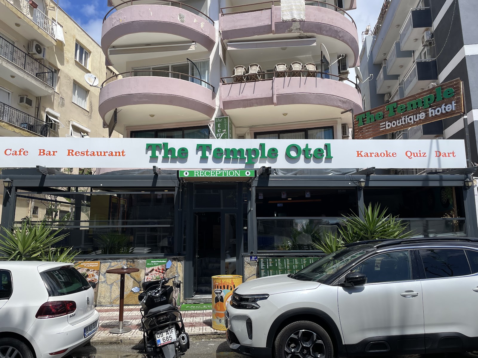 The Temple Otel building front with balconies, the reception entrance and the café bar restaurant sign