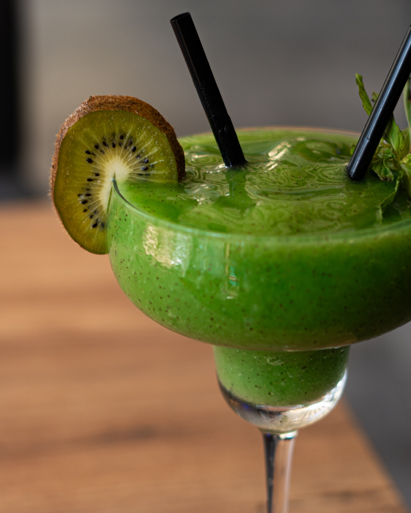 Frozen fresh kiwi daiquiri garnished with a kiwi slice