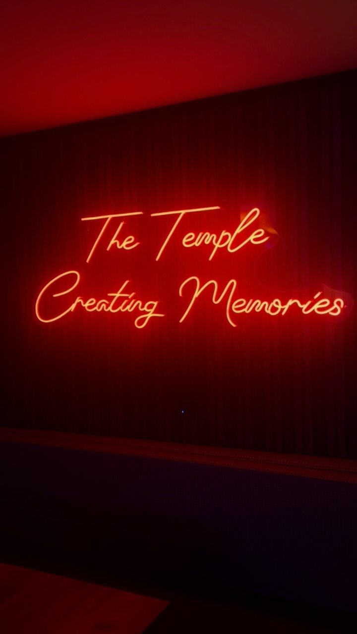 Red neon sign reading The Temple, Creating Memories