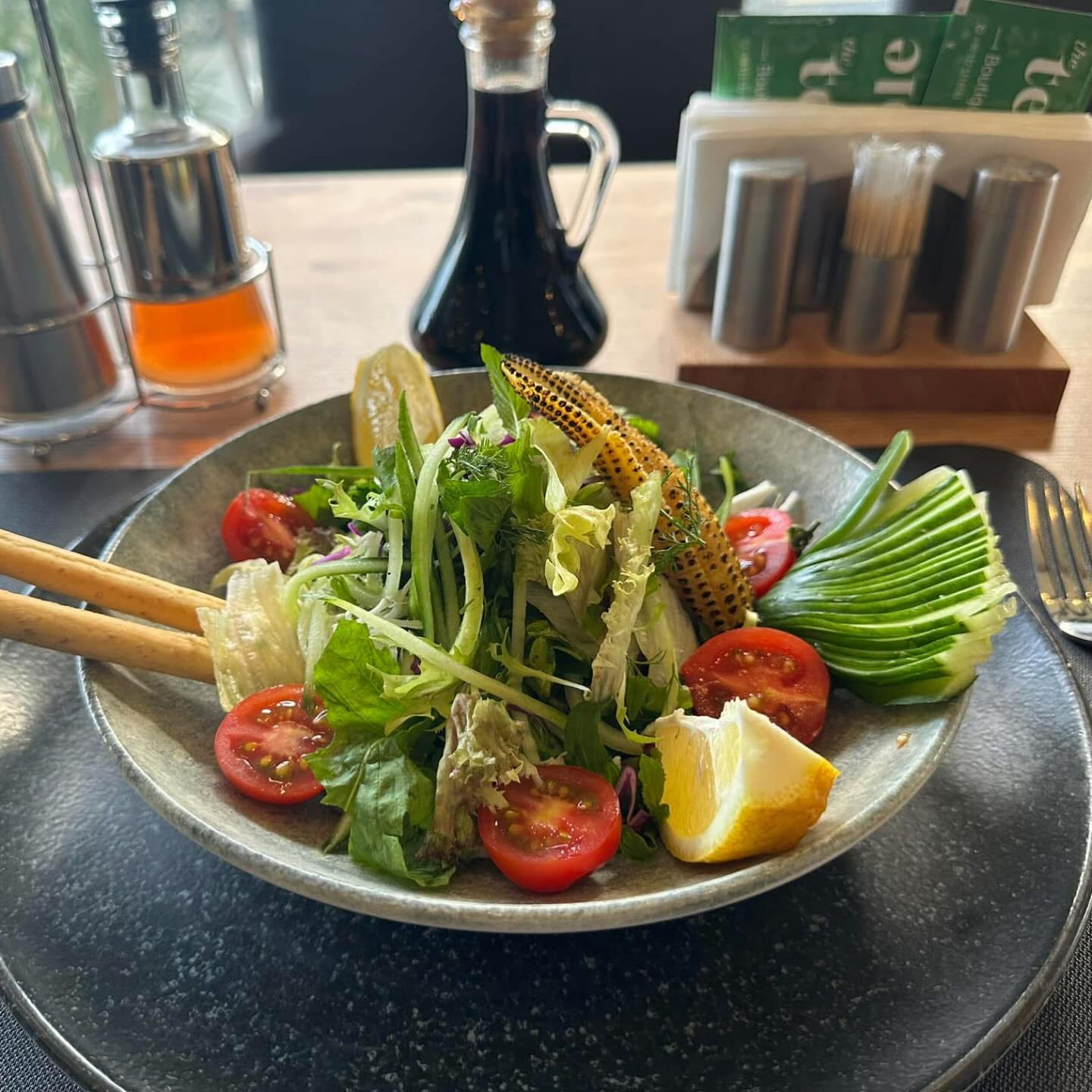 Season salad with cherry tomatoes, grilled corn, avocado and lemon
